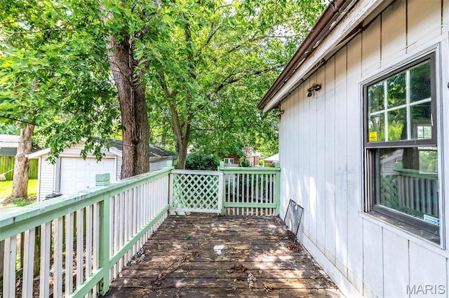 1723 Mccready Ave, Saint Louis, MO 63117 - wooden deck featuring a garage and an outbuilding