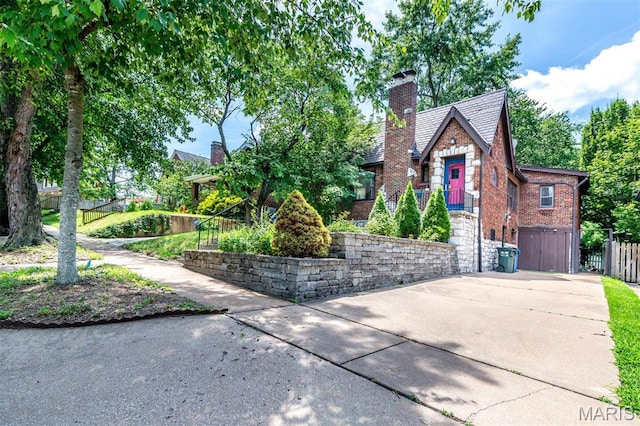 1723 Mccready Ave, Saint Louis, MO 63117 - view of front of home featuring a chimney, brick siding, and stone siding
