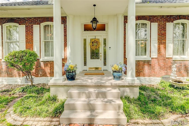 339 E Ml, Millstadt, IL 62260 - property entrance featuring brick siding, a porch, and roof with shingles