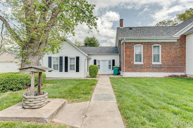 339 E Ml, Millstadt, IL 62260 - view of front of house featuring a chimney, a front yard, brick siding, and a shingled roof