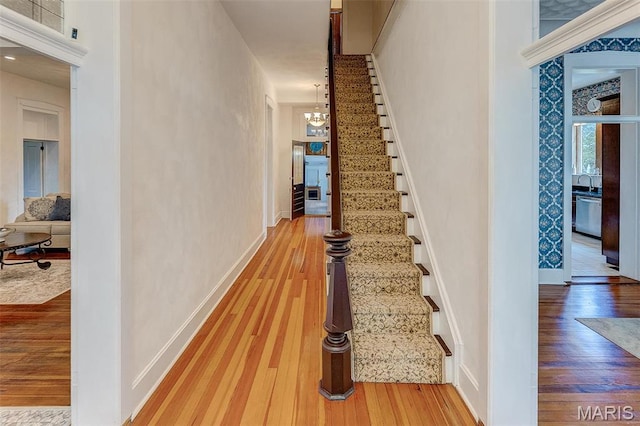 339 E Ml, Millstadt, IL 62260 - hall with hardwood / wood-style flooring, stairs, a chandelier, baseboards, and a sink