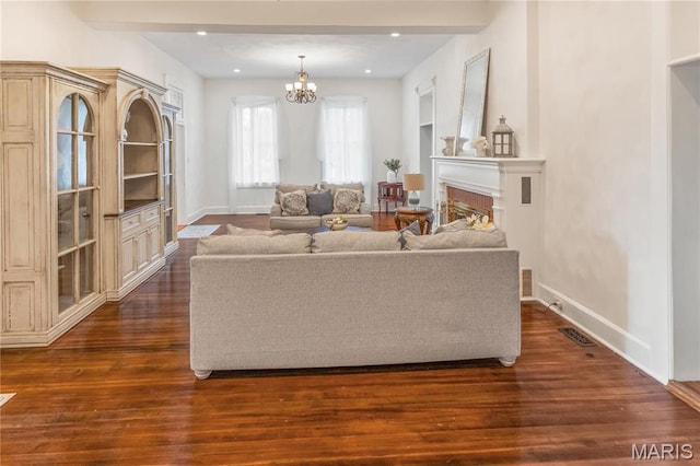339 E Ml, Millstadt, IL 62260 - living room featuring a chandelier, dark wood finished floors, and baseboards