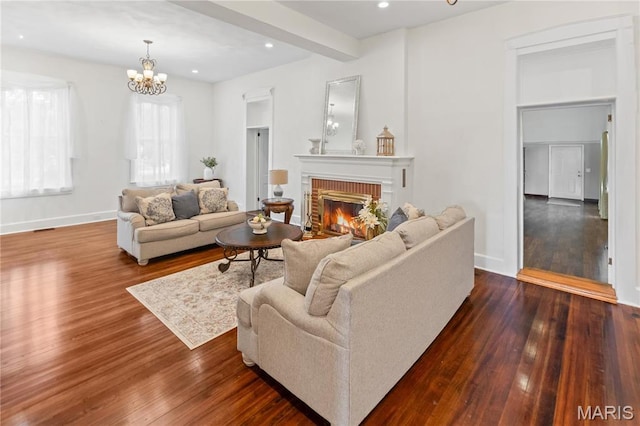 339 E Ml, Millstadt, IL 62260 - living area with dark wood-style flooring, a fireplace, a chandelier, baseboards, and recessed lighting