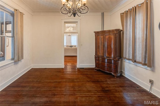 339 E Ml, Millstadt, IL 62260 - unfurnished dining area featuring dark wood-style floors, a chandelier, ornamental molding, and baseboards
