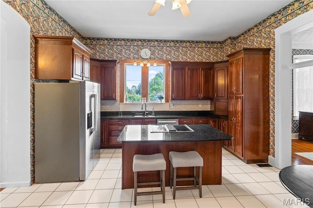 339 E Ml, Millstadt, IL 62260 - kitchen with stainless steel appliances, wallpapered walls, a sink, ceiling fan, and a kitchen island