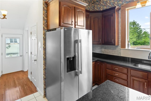 339 E Ml, Millstadt, IL 62260 - kitchen with stainless steel refrigerator with ice dispenser, a sink, lofted ceiling, tasteful backsplash, and dark stone counters