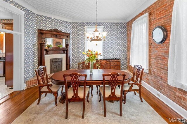 339 E Ml, Millstadt, IL 62260 - dining space featuring light wood finished floors, baseboards, a chandelier, and wallpapered walls