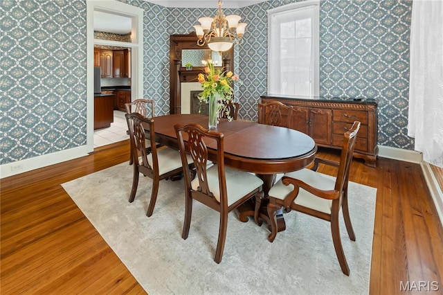 339 E Ml, Millstadt, IL 62260 - dining area with wallpapered walls, light wood-style flooring, baseboards, and a chandelier
