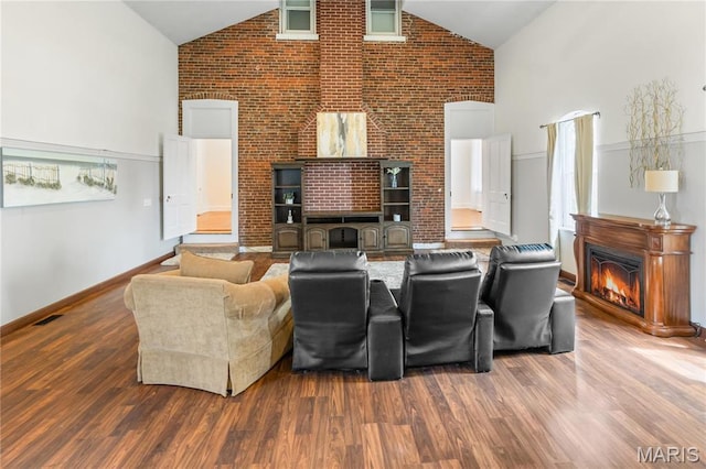 339 E Ml, Millstadt, IL 62260 - living area featuring high vaulted ceiling, a warm lit fireplace, wood finished floors, and baseboards