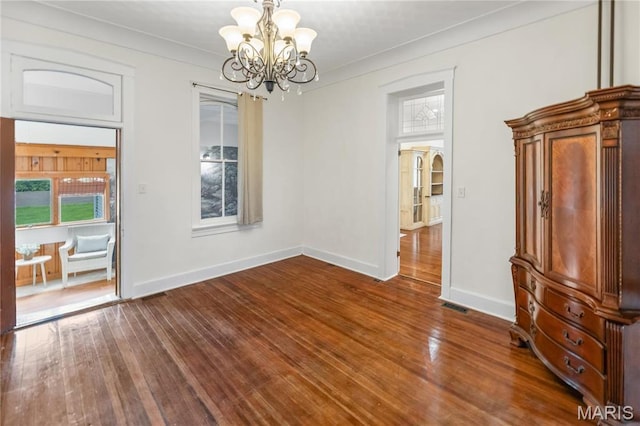 339 E Ml, Millstadt, IL 62260 - unfurnished dining area with a chandelier, wood finished floors, baseboards, and plenty of natural light