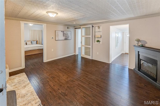 339 E Ml, Millstadt, IL 62260 - unfurnished living room featuring crown molding, an ornate ceiling, wood-type flooring, a glass covered fireplace, and baseboards
