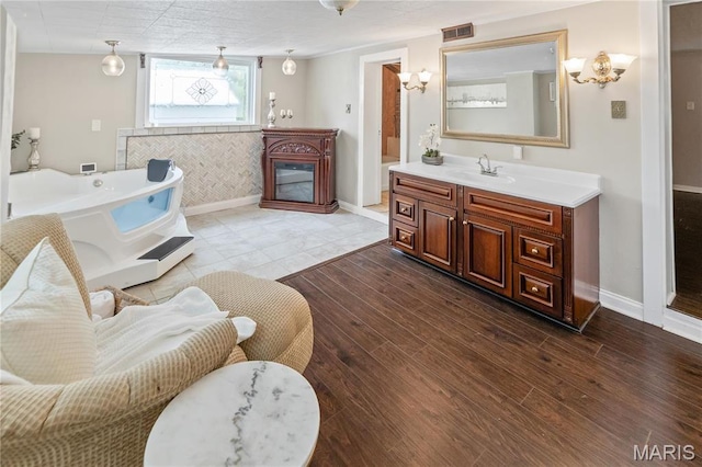 339 E Ml, Millstadt, IL 62260 - bathroom featuring baseboards, a bath, and wood finished floors