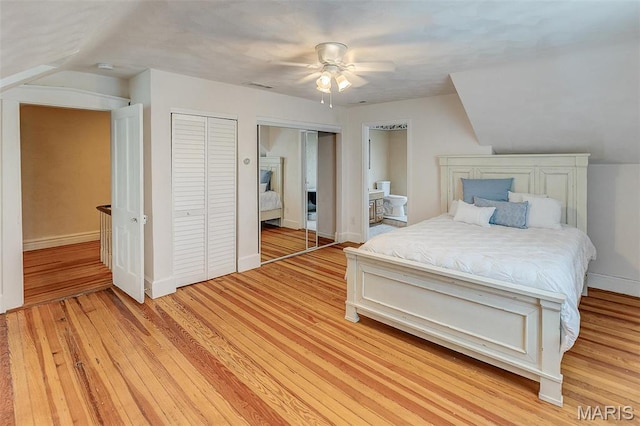 339 E Ml, Millstadt, IL 62260 - bedroom featuring multiple closets, light wood-style flooring, and baseboards