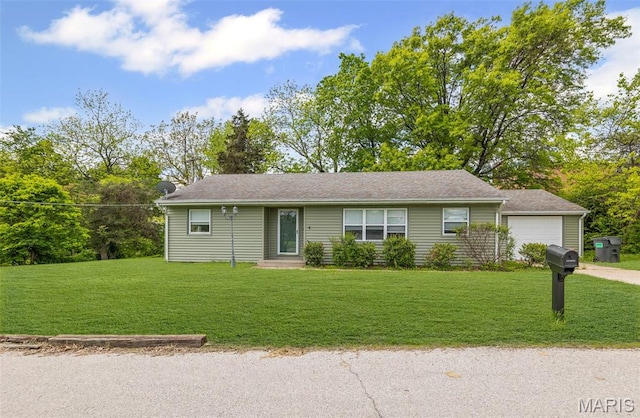 single story home featuring a garage, a front yard, and driveway