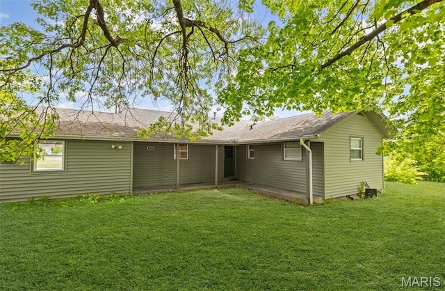 rear view of house with a yard