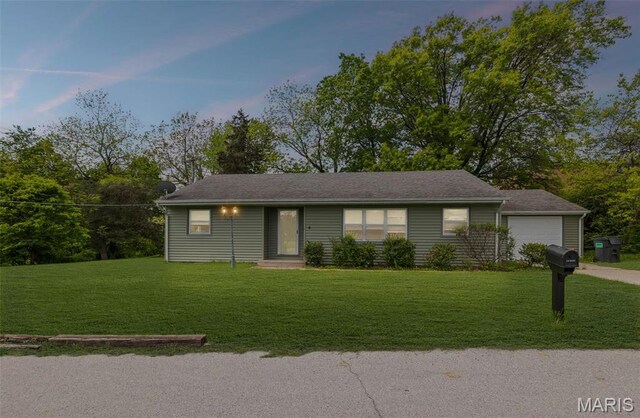 single story home with a front lawn and driveway