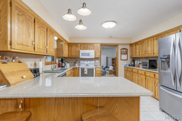 kitchen with white appliances, a peninsula, decorative backsplash, a sink, and light tile patterned floors