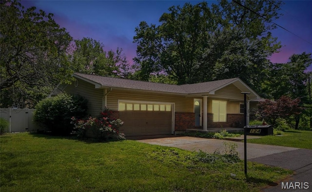 124 Dawn Dr, Washington, MO 63090 - ranch-style home with a garage, driveway, brick siding, and a gate
