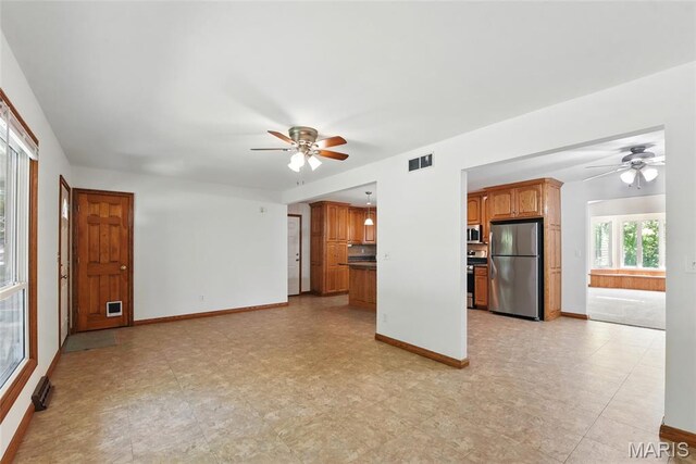 124 Dawn Dr, Washington, MO 63090 - unfurnished living room with a ceiling fan and baseboards