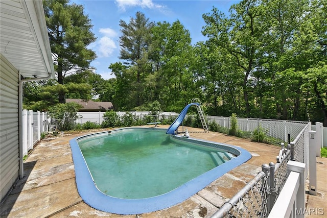 124 Dawn Dr, Washington, MO 63090 - view of swimming pool with a water slide and a fenced backyard