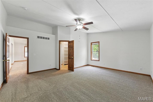 124 Dawn Dr, Washington, MO 63090 - unfurnished bedroom with carpet floors, lofted ceiling, baseboards, and a walk in closet