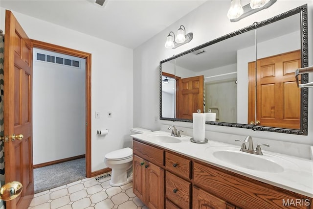 124 Dawn Dr, Washington, MO 63090 - full bath featuring toilet, double vanity, baseboards, and tile patterned floors