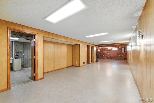 124 Dawn Dr, Washington, MO 63090 - finished basement with wood walls, a textured ceiling, a water softener system, and light flooring