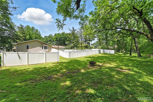 124 Dawn Dr, Washington, MO 63090 - view of yard featuring an outdoor fire pit and view of wooded area