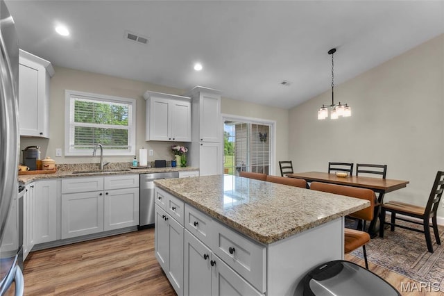 1111 Tulach Ard Ct, Jackson, MO 63755 - kitchen with appliances with stainless steel finishes, a sink, light wood-type flooring, plenty of natural light, and vaulted ceiling