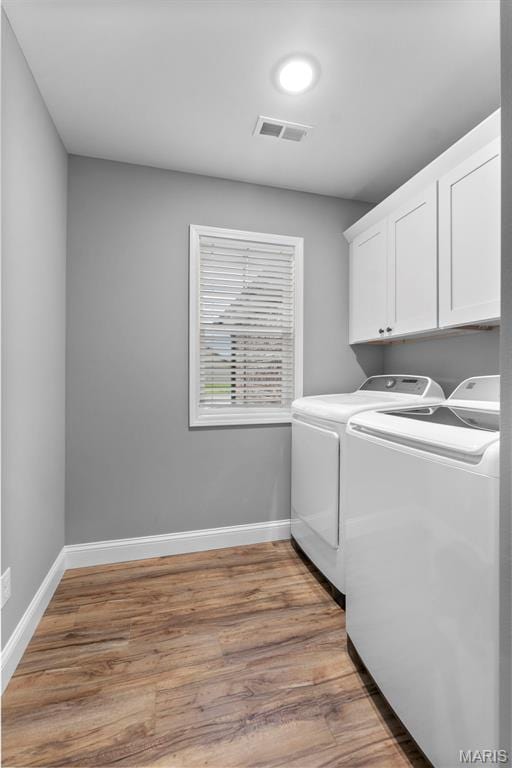 1111 Tulach Ard Ct, Jackson, MO 63755 - washroom with washer and dryer, cabinet space, baseboards, and light wood-style floors