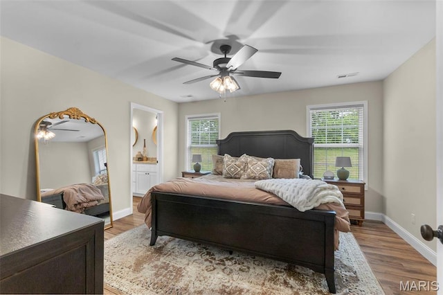1111 Tulach Ard Ct, Jackson, MO 63755 - bedroom featuring multiple windows, wood finished floors, and baseboards