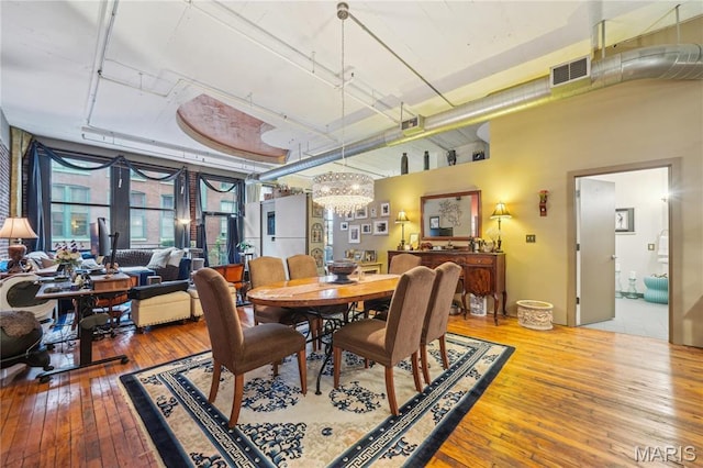 1010 Saint Charles St Unit 701, Saint Louis, MO 63101 - dining space featuring wood-type flooring and a chandelier
