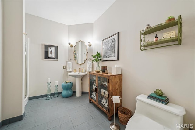 1010 Saint Charles St Unit 701, Saint Louis, MO 63101 - bathroom featuring baseboards, toilet, and tile patterned floors