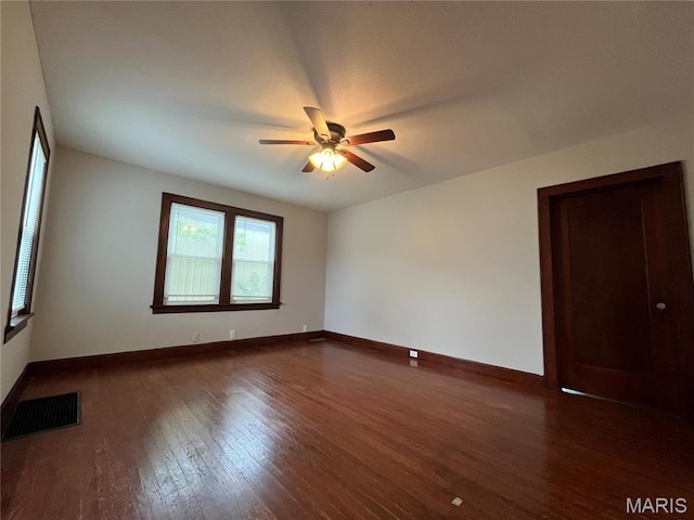 213 W Broadway, Trenton, IL 62293 - spare room with a ceiling fan, baseboards, and dark wood finished floors