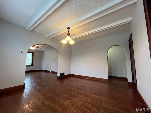 213 W Broadway, Trenton, IL 62293 - empty room featuring arched walkways, wood finished floors, beam ceiling, and baseboards