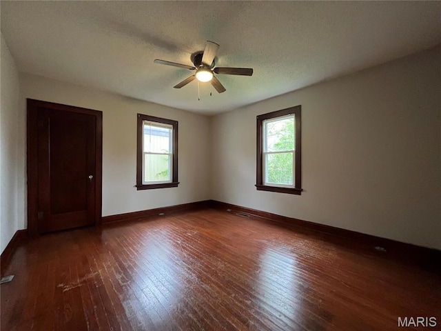 213 W Broadway, Trenton, IL 62293 - empty room featuring plenty of natural light, hardwood / wood-style floors, a ceiling fan, and baseboards