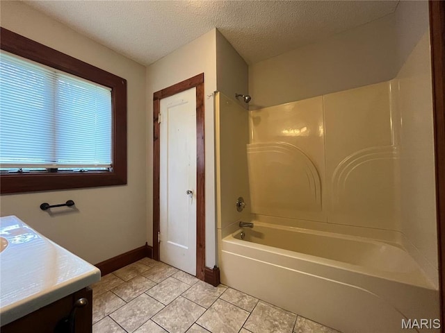 213 W Broadway, Trenton, IL 62293 - full bath with shower / washtub combination, tile patterned floors, a textured ceiling, vanity, and baseboards
