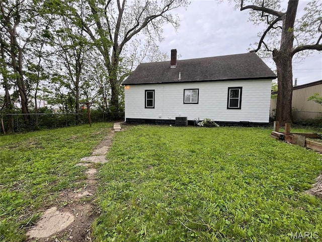 213 W Broadway, Trenton, IL 62293 - back of property featuring a chimney, roof with shingles, and central air condition unit
