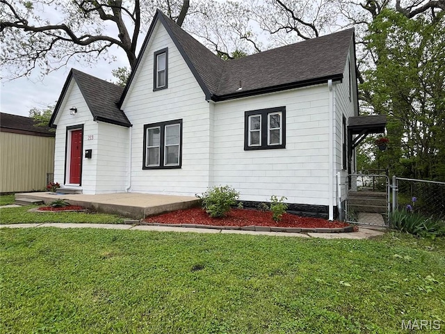 213 W Broadway, Trenton, IL 62293 - view of front of home featuring a front yard and roof with shingles