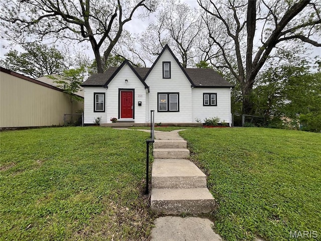 213 W Broadway, Trenton, IL 62293 - view of front of house with a front lawn and a shingled roof