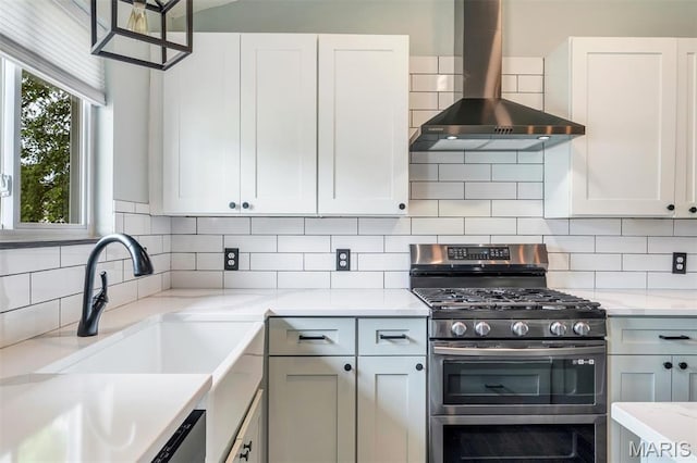 159 Village Circle Dr, Lake St Louis, MO 63367 - kitchen featuring range with two ovens, wall chimney range hood, tasteful backsplash, and light stone countertops