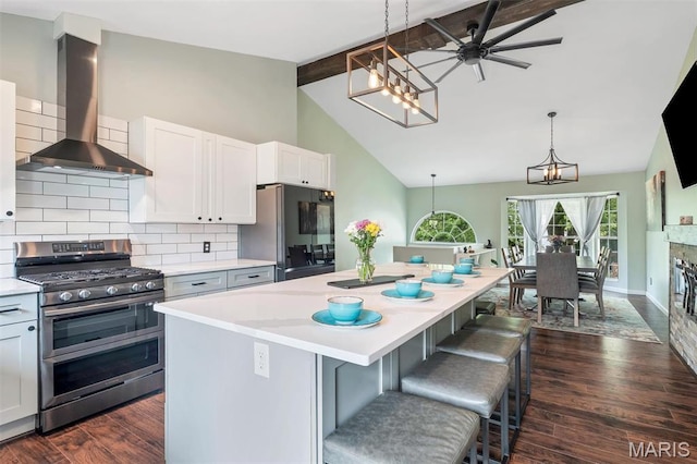 159 Village Circle Dr, Lake St Louis, MO 63367 - kitchen featuring range with two ovens, wall chimney range hood, fridge, a chandelier, and backsplash
