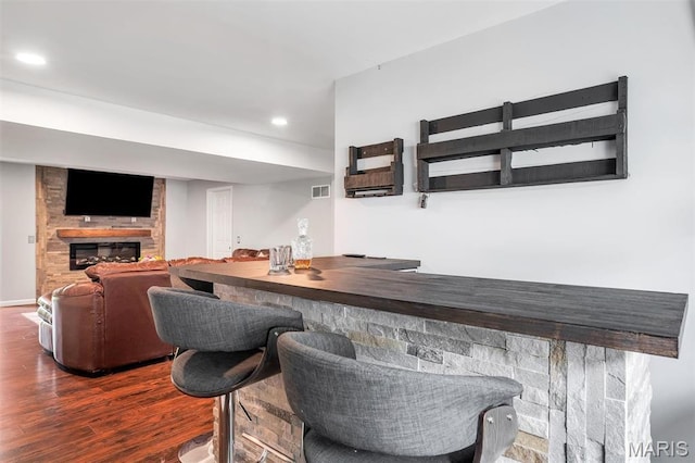 159 Village Circle Dr, Lake St Louis, MO 63367 - indoor bar featuring wood finished floors, a large fireplace, and recessed lighting