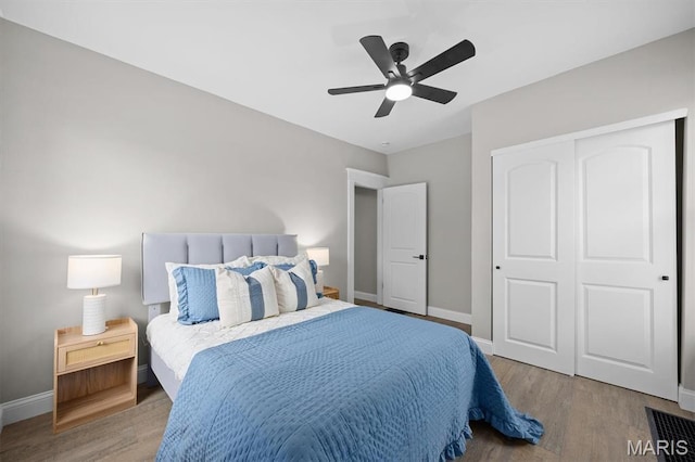 1219 Exchange St, Alton, IL 62002 - bedroom with baseboards, wood finished floors, a closet, and a ceiling fan