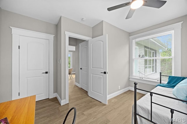 1219 Exchange St, Alton, IL 62002 - bedroom with light wood finished floors, baseboards, and a ceiling fan