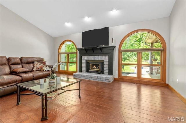 2453 Lone Trail Dr, Foristell, MO 63348 - living area featuring lofted ceiling, a fireplace, and wood-type flooring
