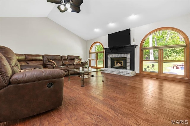 2453 Lone Trail Dr, Foristell, MO 63348 - living room featuring a ceiling fan, wood finished floors, a brick fireplace, and high vaulted ceiling