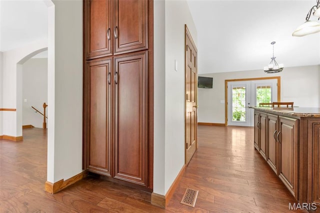 2453 Lone Trail Dr, Foristell, MO 63348 - hall featuring arched walkways, wood finished floors, an upstairs landing, and baseboards