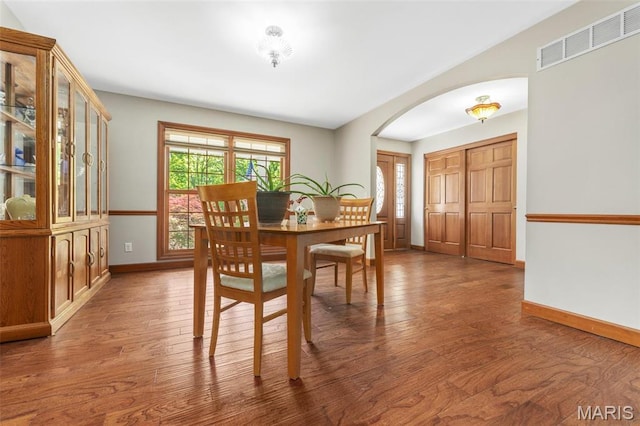 2453 Lone Trail Dr, Foristell, MO 63348 - dining space with arched walkways, wood finished floors, and baseboards