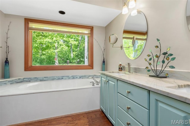 2453 Lone Trail Dr, Foristell, MO 63348 - bathroom with healthy amount of natural light, vanity, a bath, and wood finished floors